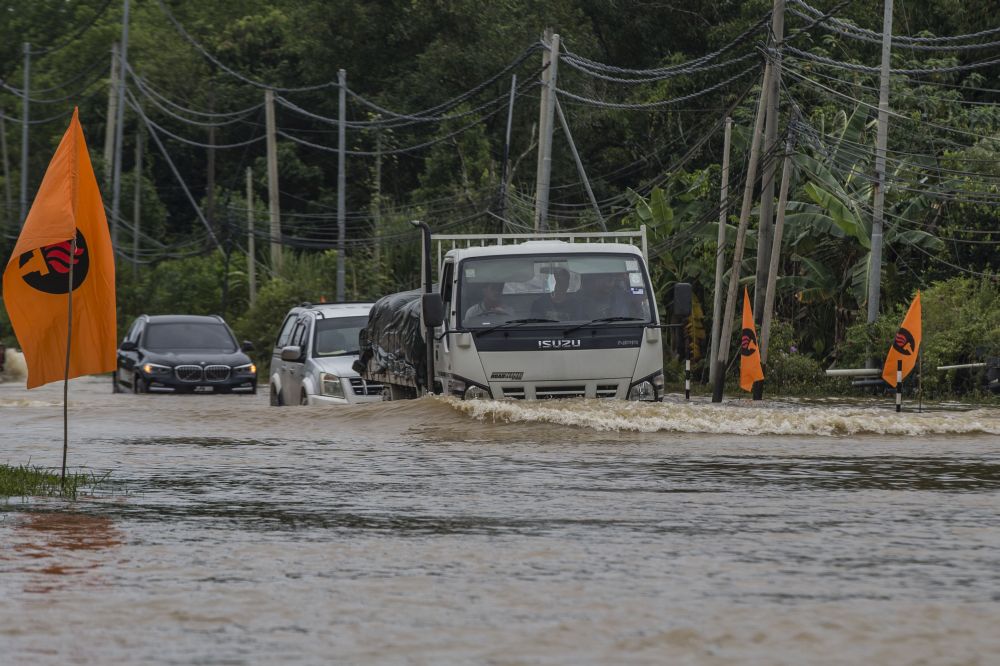 Motorists attempt to drive through flood waters on Jalan Datuk Panglima Banting in Penampang, Sabah September 15, 2020. u00e2u20acu201d Picture by Firdaus Latif