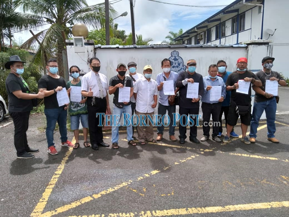 Lawarance (second right), Midi (third right), Alim (fourth right), Freedy (fifth left), Ng (fourth left) and others after lodging the police report at Mile 7 Police Station. u00e2u20acu201d Borneo Post pic 