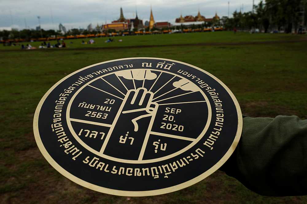 A student holds a replica of the plaque installed by students leaders near the Grand Palace, reading 'This country belongs to the people,' during a mass rally in Bangkok, Thailand September 20, 2020. u00e2u20acu201d Reuters pic