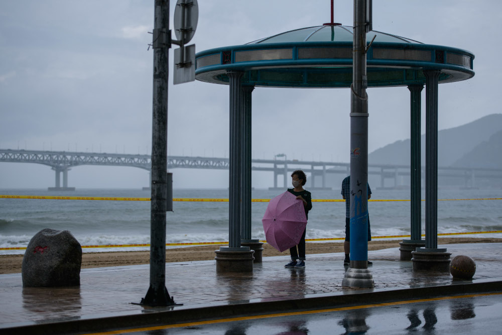 A woman stands with an umbrella before Gwangalli beach in Busan September 2, 2020. u00e2u20acu201d AFP pic 