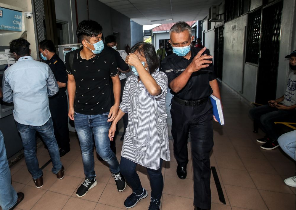 Yew Lee See (centre), 52, is pictured at the Ipoh Sessions Court September 3, 2020. u00e2u20acu2022 Picture by Farhan Najib