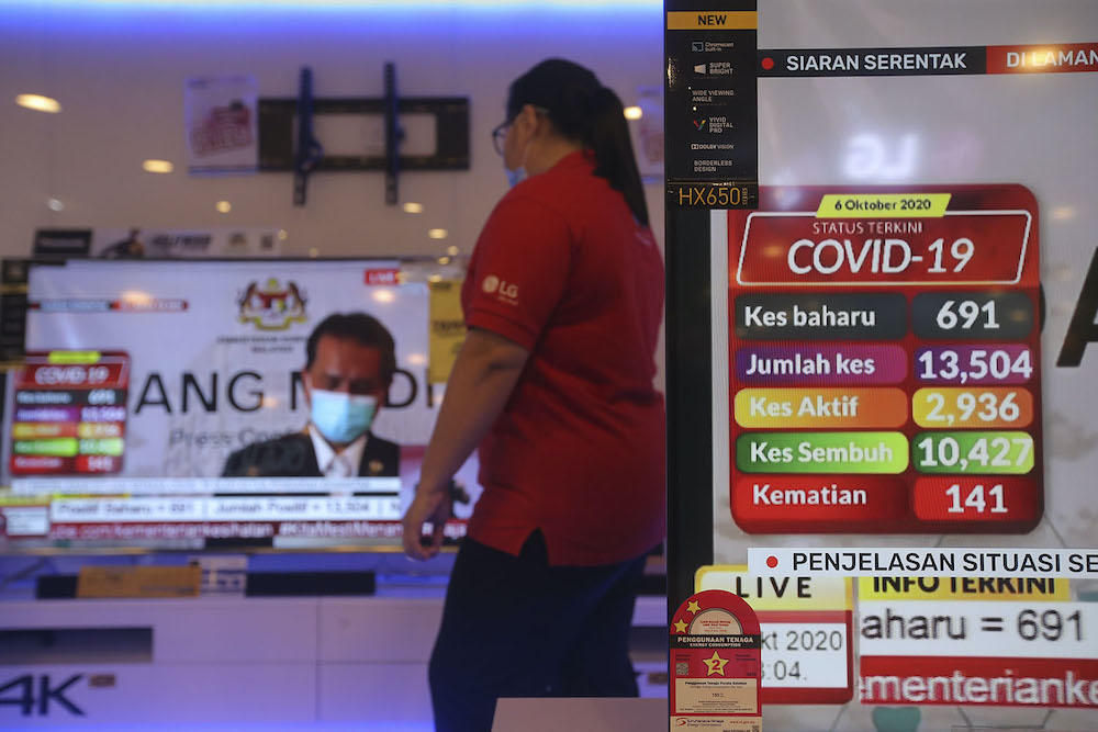 Television screens show Director General of Health Malaysia Tan Sri Dr Noor Hisham Abdullah holding a press conference from his home during his quarantine, October 6, 2020. u00e2u20acu201d Picture by Hari Anggara