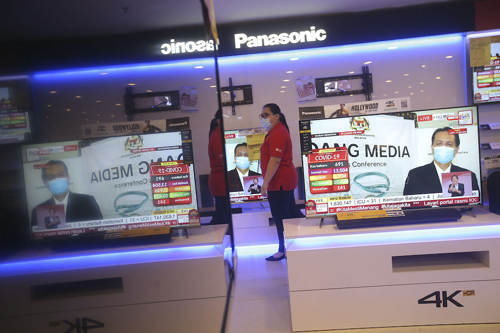 Television screens show Director General of Health Malaysia Tan Sri Dr Noor Hisham Abdullah holding a press conference from his home during his quarantine, October 6, 2020. u00e2u20acu201d Picture by Hari Anggara
