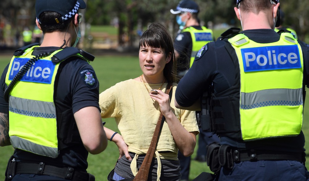 Police speak to Sheridan Lee, a naturopath and a fan of one of Australia's leading purveyors of conspiracy theories, disinformation and pseudoscience u00e2u20acu02dcPaleou00e2u20acu2122 Pete Evans, at an anti-lockdown rally in Melbourne September 19, 2020. u00e2u20acu201d AFP pic