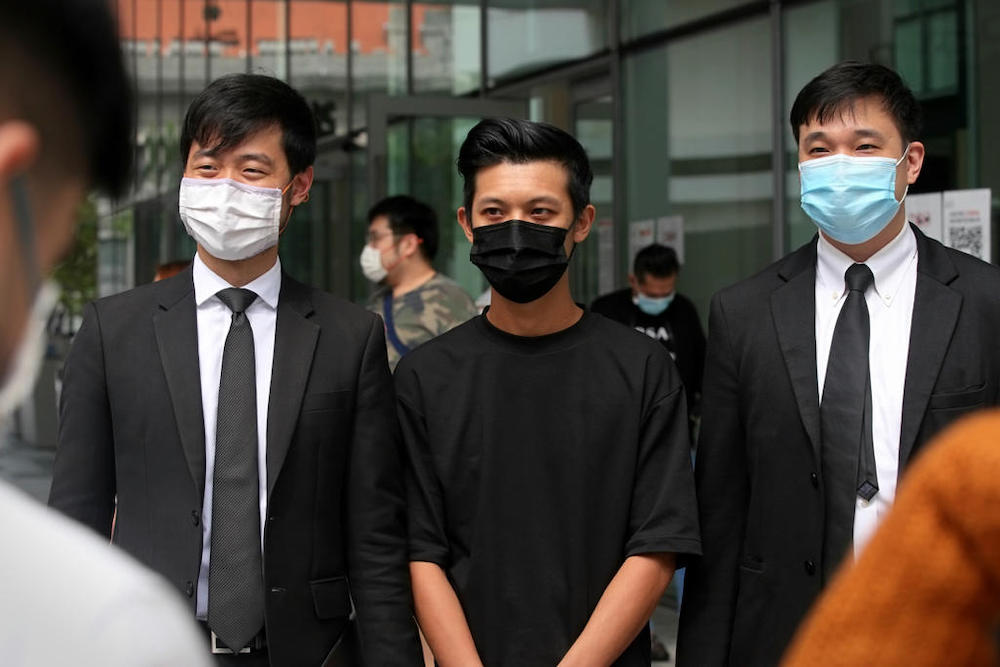 Chan Jia Xing (centre) is seen flanked by his lawyers Cory Wong (left) and Shane Yeo from Invictus Law Corporation. u00e2u20acu201d TODAY pic