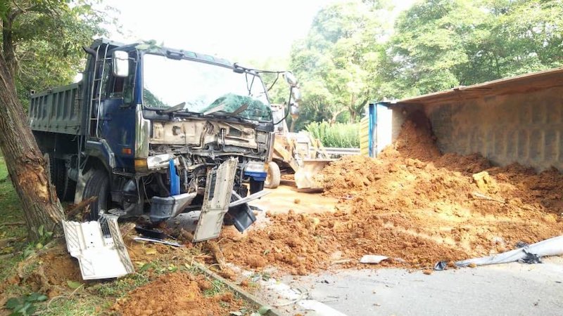 A sand truck had toppled over and covered the entire road. — Picture via Twitter/@aimadazfar.
