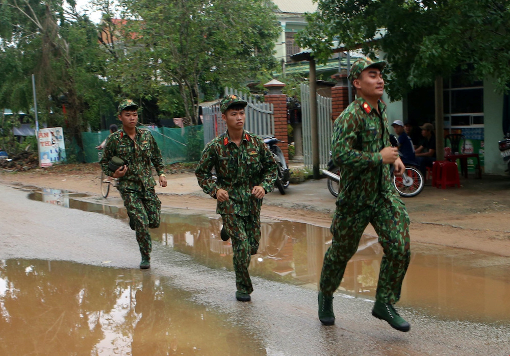 Military personnel, part of the rescue team, are deployed to search for missing people at a site of a landslide near a hydropower dam in Thua Thien Hue province, Vietnam October 14, 2020. u00e2u20acu201d Tran Le Lam/VNA handout via Reuters