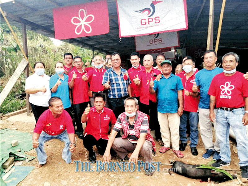 Duat (standing front, fifth left) and Ambrose, on his right, join others in a group photo taken during the assemblymanu00e2u20acu2122s visit to Bersatu service centre in Julau. u00e2u20acu201d Borneo Post Online pic