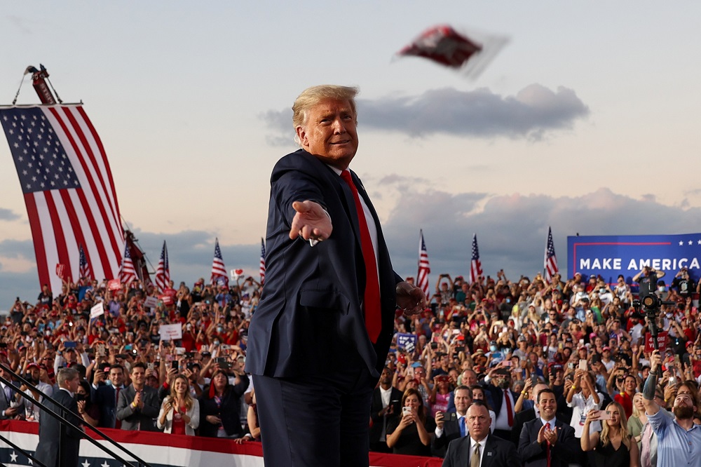 US President Donald Trump throws a face mask from the stage during a campaign rally, his first since being treated for the coronavirus disease, at Orlando Sanford International Airport October 12, 2020. u00e2u20acu201d Reuters pic