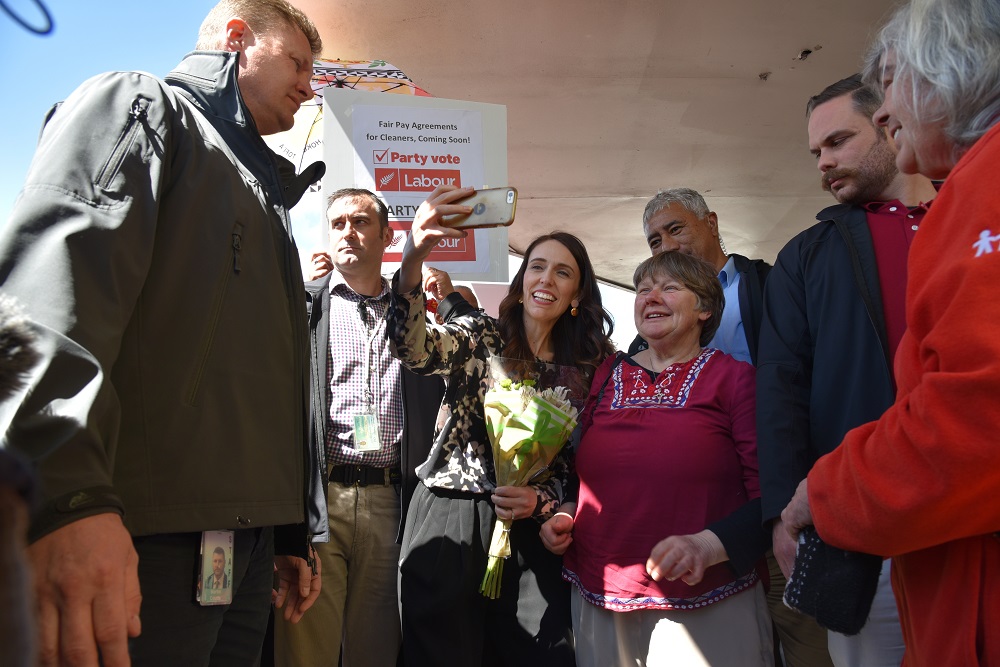 Prime Minister Jacinda Ardern takes a selfie with supporters during a streetwalk in the Auckland suburb of Onehunga on the final day of campaigning in New Zealandu00e2u20acu2122s election October 16, 2020. u00e2u20acu201d AAP Image via Reuters