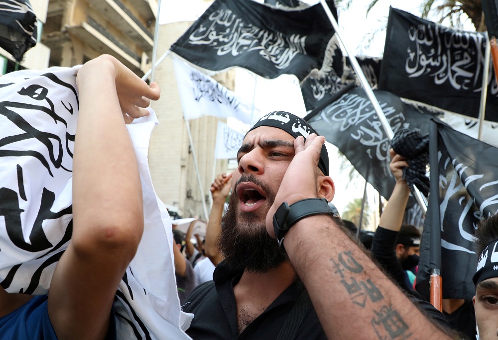 A demonstrator gestures during a protest against the cartoon publications of Prophet Mohammad in France and comments by the French President Emmanuel Macron, in Beirut October 30, 2020. — Reuters pic