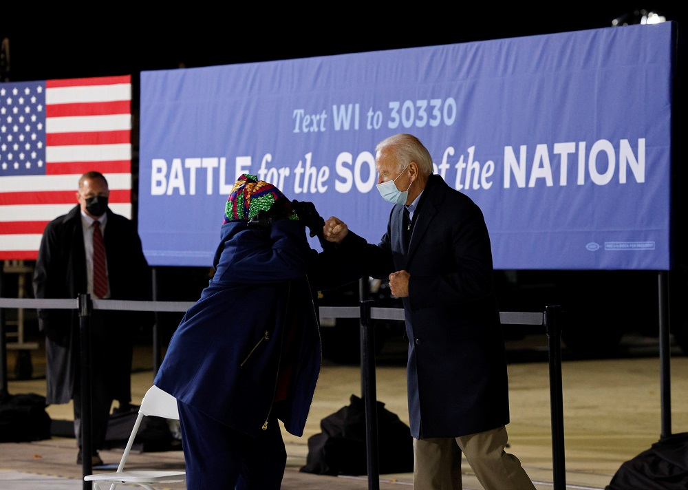 Democratic US presidential nominee and former Vice President Joe Biden interacts with US Representative Gwen Moore at a campaign stop in Milwaukee October 30, 2020. u00e2u20acu201d Reuters pic
