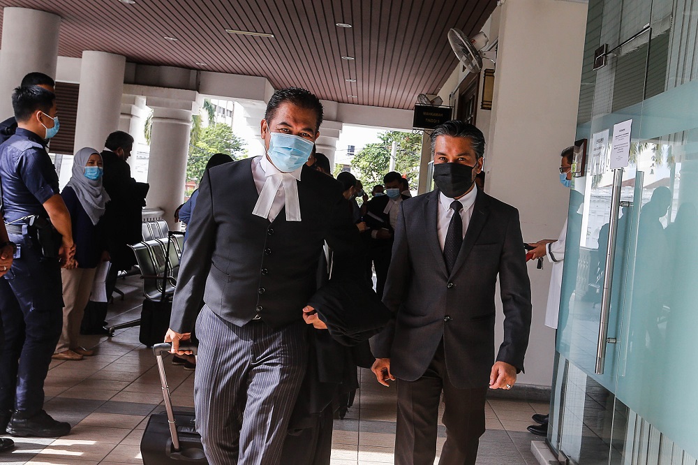 Bertam assemblyman Khaliq Mehtab Mohd Ishaq (right) and his lawyer Rosli Dahlan leave the Penang High Court October 9, 2020. u00e2u20acu201d Picture by Sayuti Zainudin