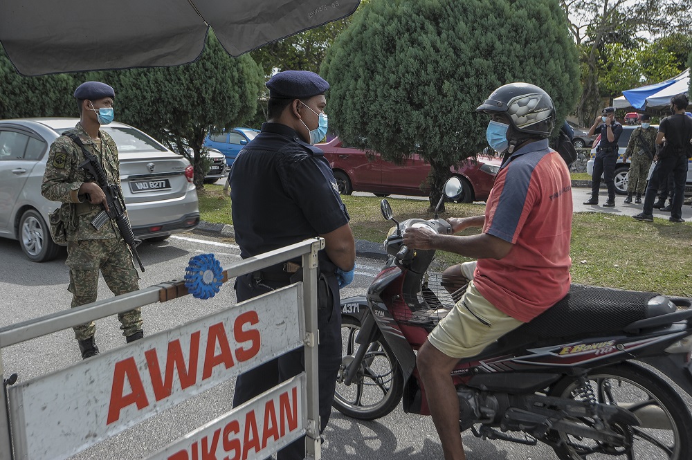 A motorcyclist is stopped at a roadblock at Taman Sri Andalas in Klang October 10, 2020. u00e2u20acu201d Picture by Shafwan Zaidon