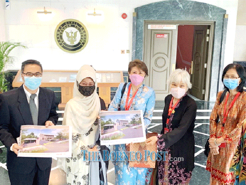 Fatimah (second left), together with Azerina (centre) and Dr Ong (second right) show the proposed depiction of the new building. u00e2u20acu201d Photo by DASwk via Borneo Post Online