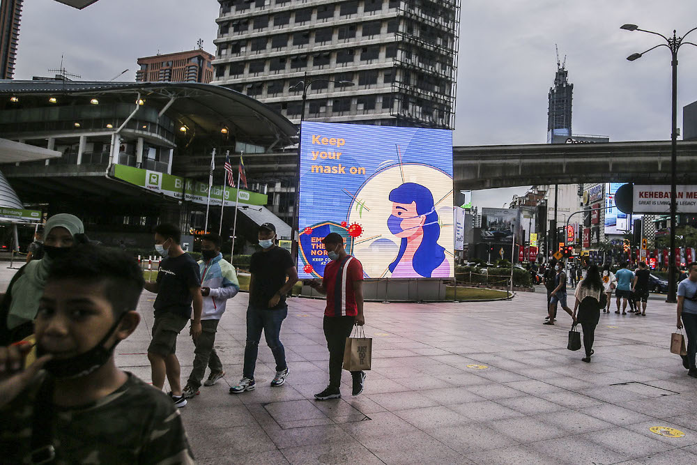 A billboard displaying Covid-19 SOP issued by the government is seen in Kuala Lumpur October 11, 2020. — Picture by Hari Anggara