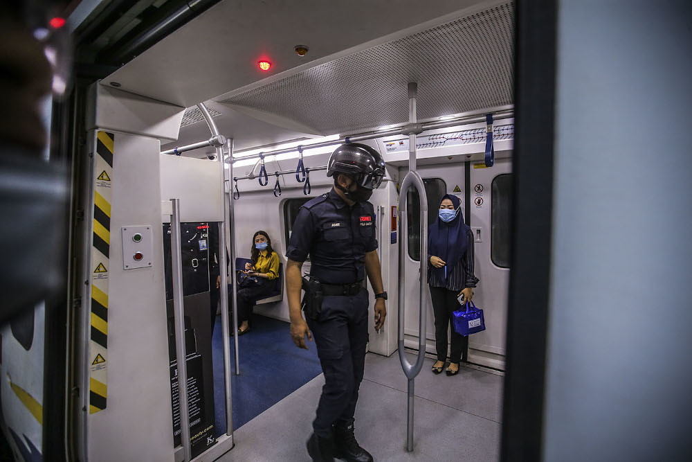 A general picture of the KTMB auxiliary police wearing temperature scanner helmets to patrol its station and trains during the CMCO in KL Sentral October 14, 2020. — Picture by Hari Anggara
