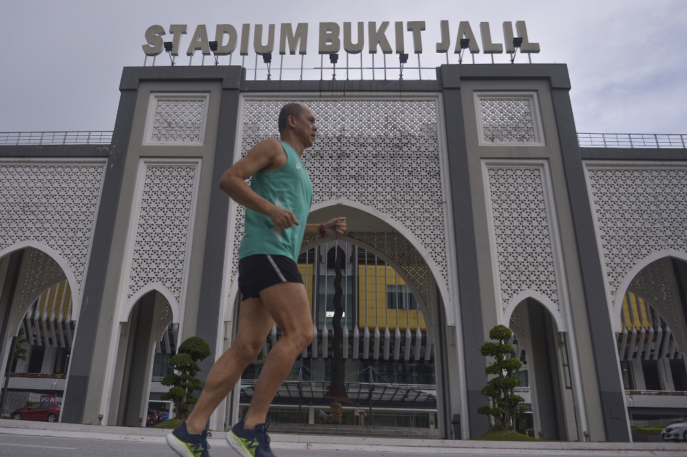 A jogger is seen at Bukit Jalil Stadium during the conditional movement control order on October 14, 2020. u00e2u20acu201d Picture by Miera Zulyana