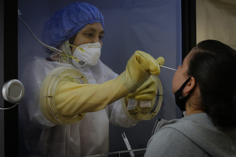 A health worker inside a protective chamber collects swab samples to test for Covid-19 at the Sunway Medical Centre in Subang Jaya October 15, 2020. u00e2u20acu201d Picture by Yusof Mat Isa