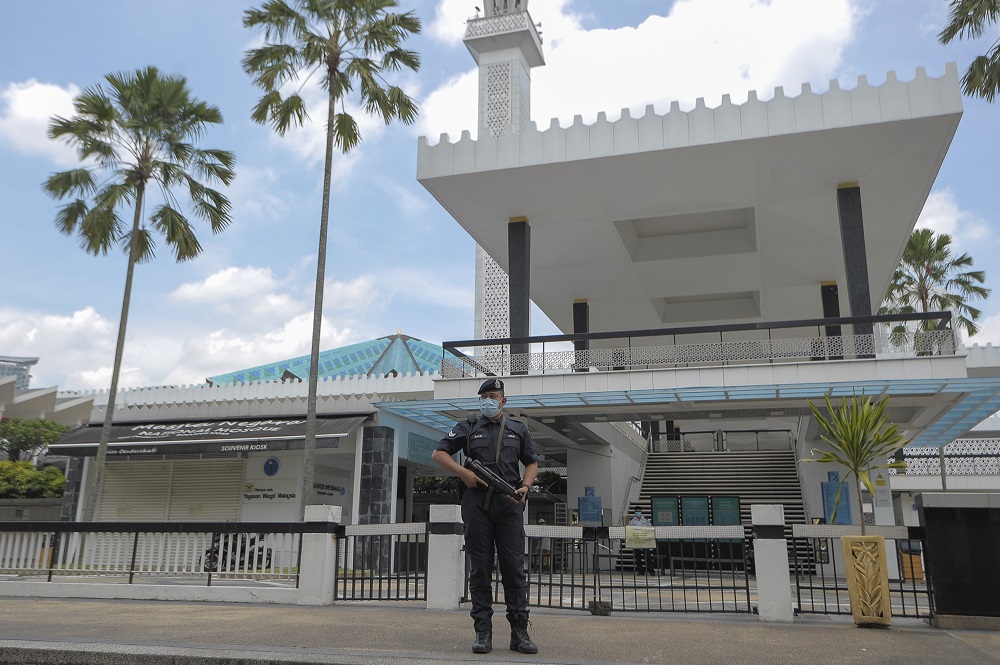 A police officer stands guard outside the National Mosque amid the conditional movement control order in Kuala Lumpur October 16, 2020. u00e2u20acu201d Picture by Shafwan Zaidon