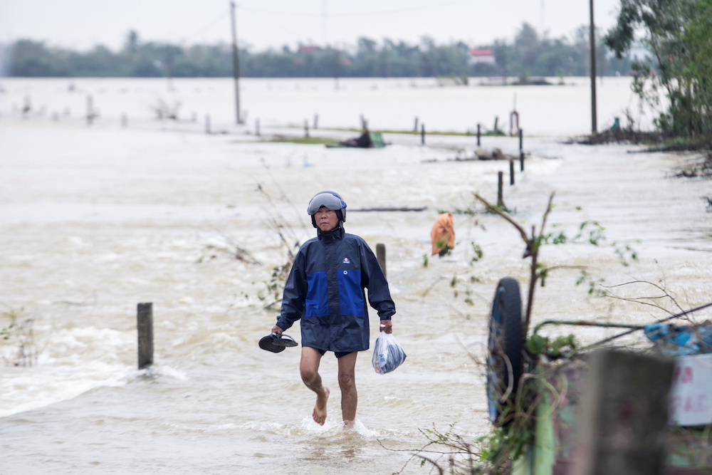 A local resident walks through floodwater to a pickup point for relief packages in Quang An Commune, Thua Thien Hue, Vietnam, October 20, 2020. u00e2u20acu201d Reuters pic