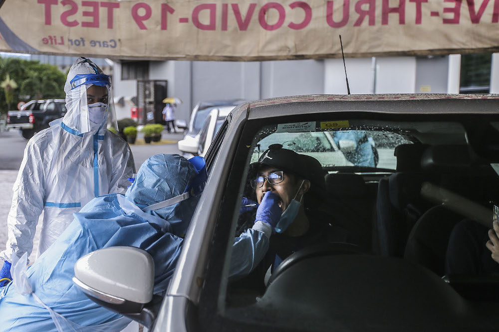 Healthcare workers carry out Covid-19 screening in Kuala Lumpur October 21, 2020. u00e2u20acu201d Picture by Hari Anggara