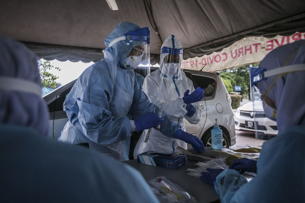 Healthcare workers carry out Covid-19 screening in Kuala Lumpur October 21, 2020. u00e2u20acu201d Picture by Hari Anggara