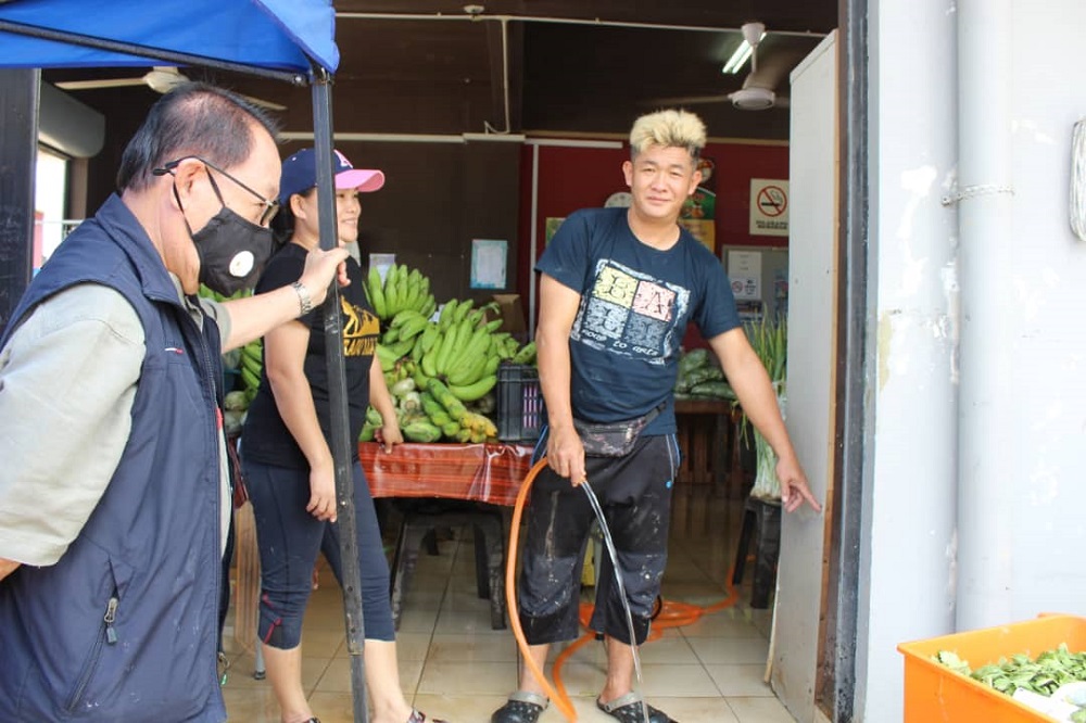 Deputy Chief Minister Datuk Seri Panglima Jeffrey Kitingan listening to a shopowner affected by the Monday flooding in Tenghilan. u00e2u20acu201d Borneo Post Online pic