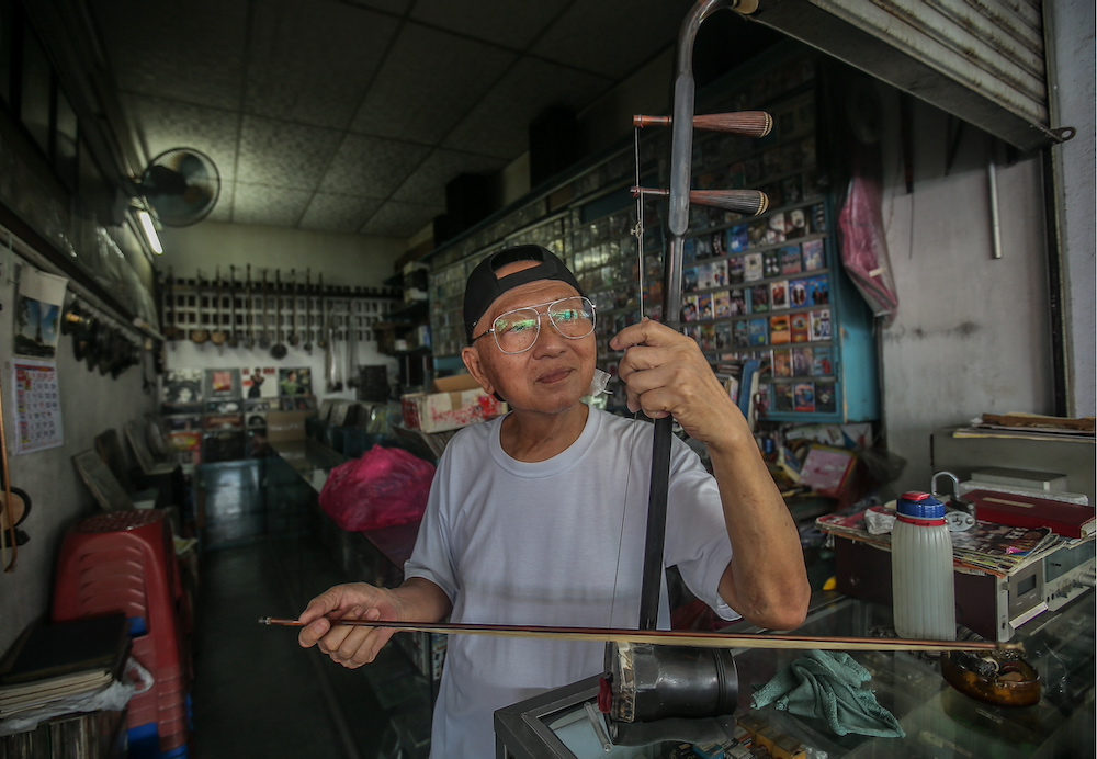 Cheng often finds himself wiling the time away at his store playing the erhu. — Picture by Farhan Najib