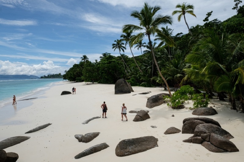 Tourists walking on the beach with granite rocks on Silhouette Island, the third largest island of Seychelles. u00e2u20acu201d AFP pic