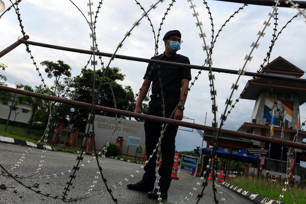 A policeman mans the roadblock at the entrance to the Seberang Perai Prison Quarters after the implementation of the enhanced movement control order at Seberang Perai Prison, Nibong Tebal October 22, 2020. u00e2u20acu201d Picture by Sayuti Zainudin
