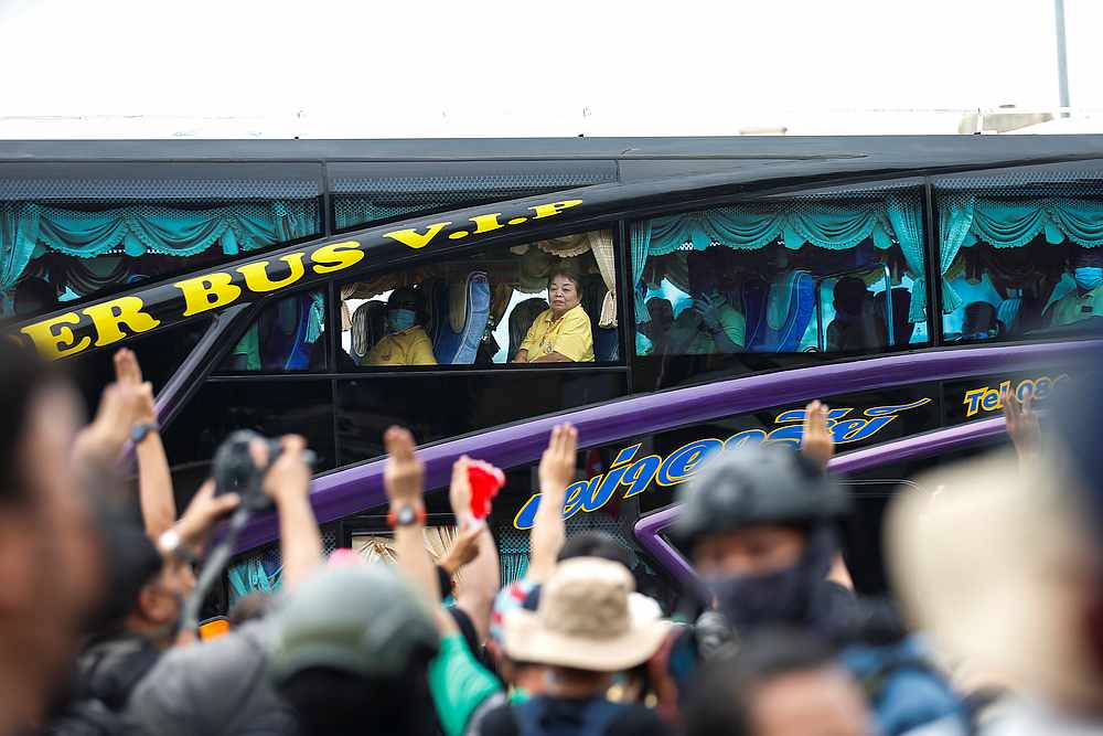 People flash the three-fingers salute as a royalists' bus passes near them during a Thai anti-government mass protest, on the 47th anniversary of the 1973 student uprising, in Bangkok, Thailand October 14, 2020. u00e2u20acu201d Reuters pic
