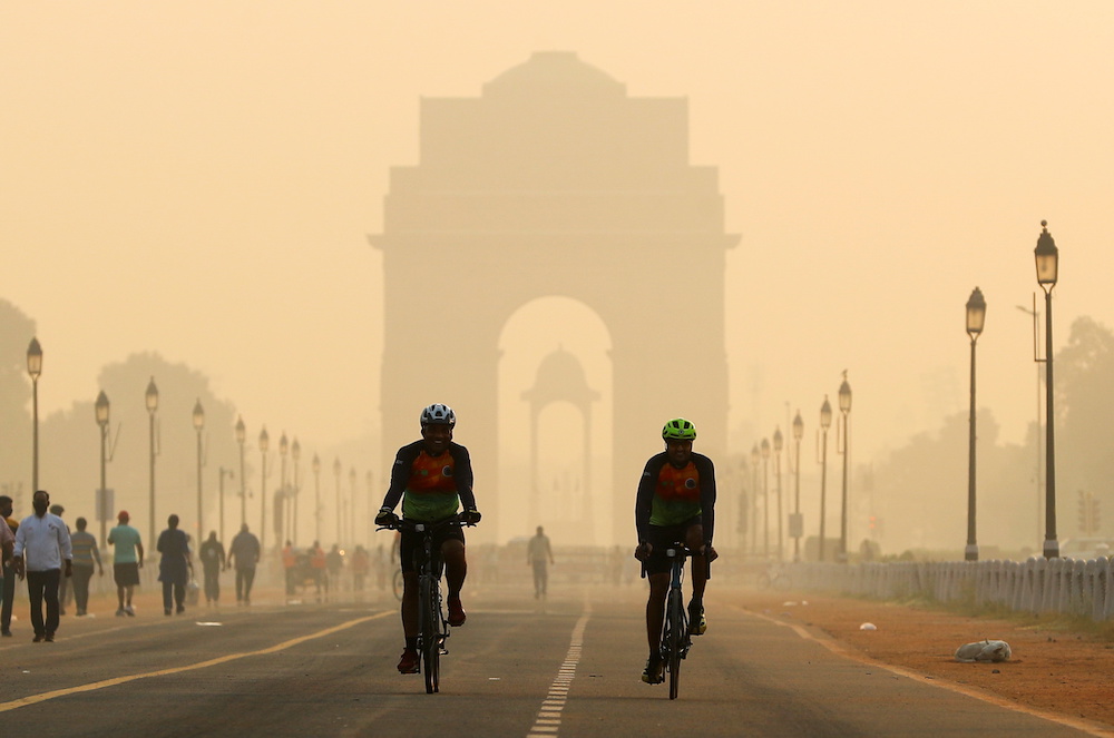 Men ride their bicycles in front of the India Gate shrouded in smog, in New Delhi, India, October 24, 2020. u00e2u20acu2022 Reuters picnnn