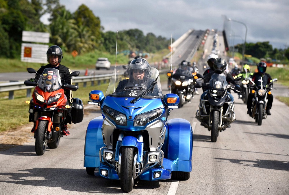 Sarawak Chief Minister Datuk Patinggi Abang Johari Openg (centre) rides his 1800cc Honda Goldwing trike motorcycle during a working visit to Kapit October 4, 2020. u00e2u20acu201d Bernama pic
