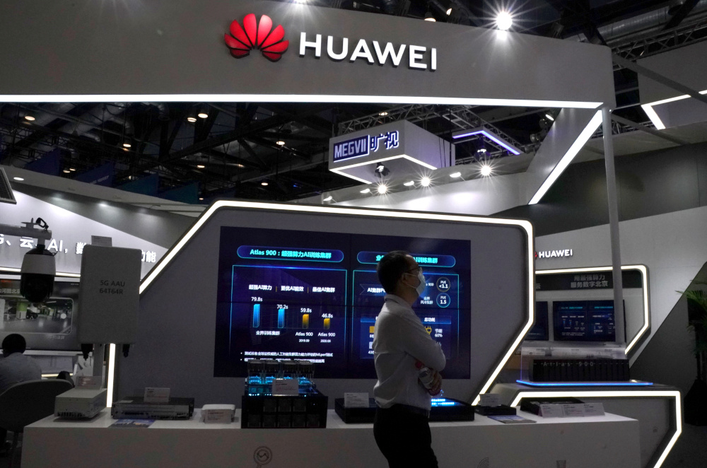 A man wearing a face mask following the coronavirus disease outbreak walks past a booth of Huawei at the 2020 China International Fair for Trade in Services in Beijing, China September 4, 2020. u00e2u20acu201d Reuters pic