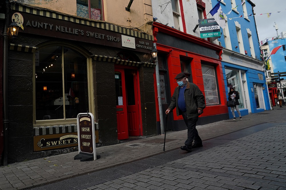 A man wearing a protective face mask walks along a street in the city centre of Galway, Ireland October 5, 2020. u00e2u20acu2022 Reuters pic