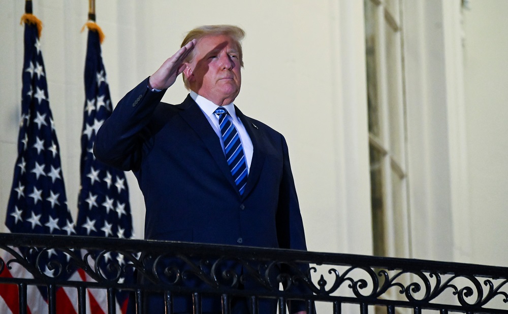US President Donald Trump salutes as he poses without a face mask on the Truman Balcony of the White House in Washington October 5, 2020. u00e2u20acu2022 Reuters pic