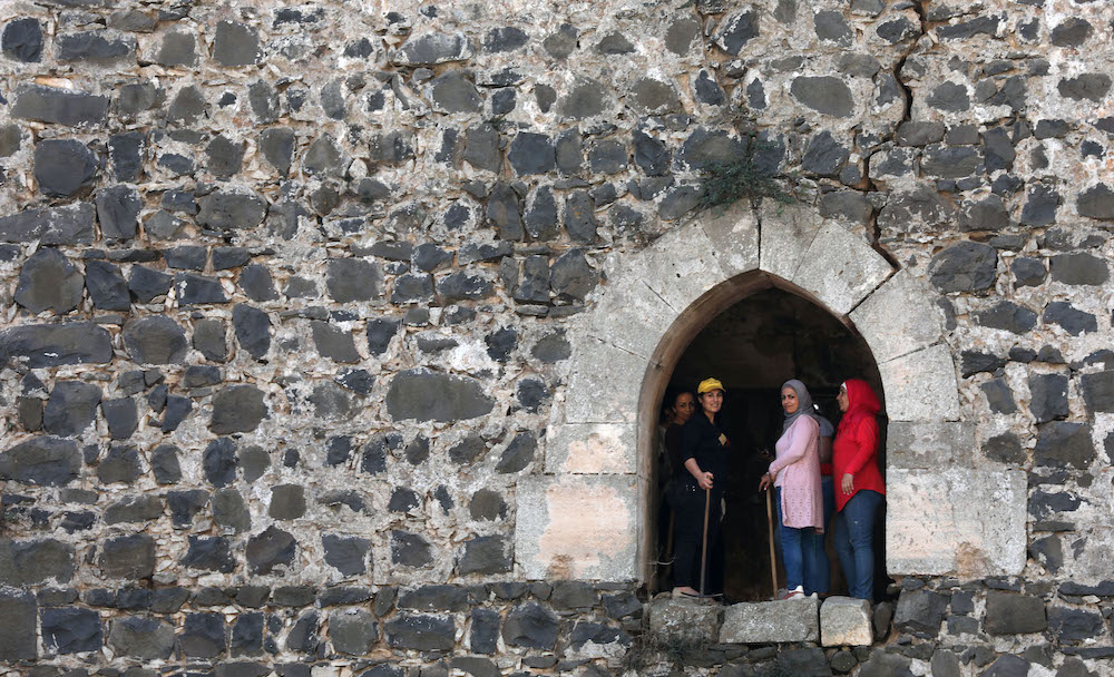 Volunteers take part in a clean-up at the medieval Crusader fortress Krak des Chevaliers, approximately 40 kilometres west of Syria's central city of Homs and close to the border with Lebanon. u00e2u20acu2022 AFP picnnn