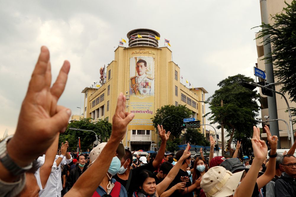 A portrait of King Maha Vajiralongkorn is seen as pro-democracy demonstrators give a three-finger salute while marching during a Thai anti-government mass protest in Bangkok October 14, 2020. u00e2u20acu201d Reuters pic