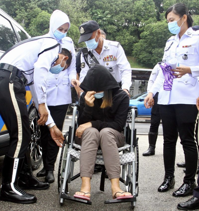 Nur Fatin Nazrah Suhaimi, 23, is brought to the Johor Baru Magistrate's Court by traffic police October 15, 2020. u00e2u20acu201d Picture by Ben Tannn