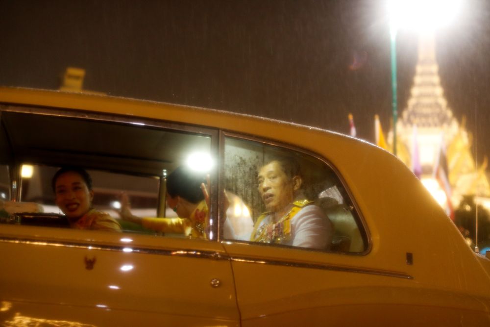 Thailandu00e2u20acu2122s King Maha Vajiralongkorn and Queen Suthida depart in a car after greeting royalist supporters who gathered outside the Grand Palace to mark the 4th anniversary of late King Bhumibol Adulyadeju00e2u20acu2122s death, in Bangkok, Thailand, October 13, 2020.