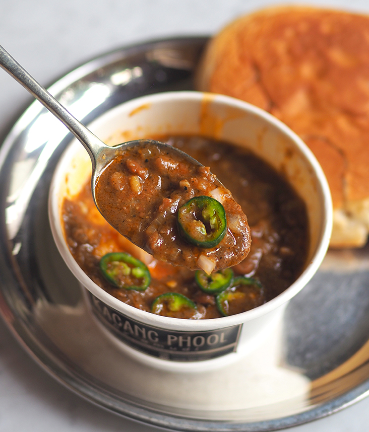 The 'kacang phool' is served with crunchy green chillies, onions and fried egg.