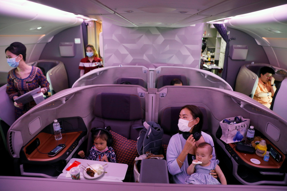 A Singapore Airlines stewardess serves food in the business class cabin of their A380 restaurant at Changi Airport in Singapore October 24, 2020. ― Reuters pic