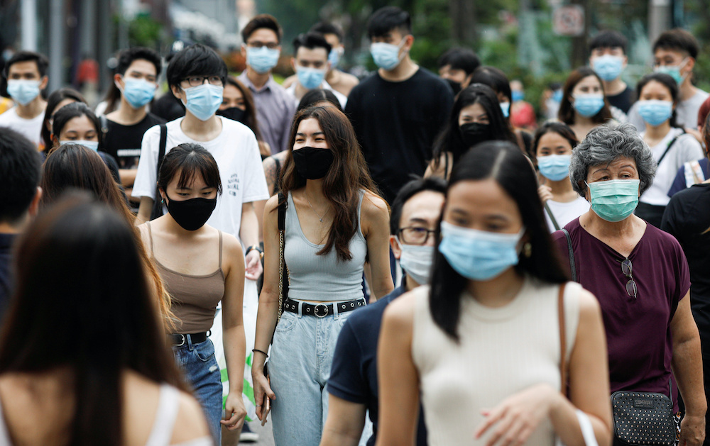 File photo of people crossing a street at the shopping district of Orchard Road amid the coronavirus outbreak in Singapore June 19, 2020. u00e2u20acu2022 Reuters pic