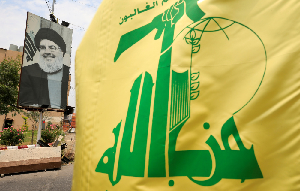 A Hezbollah flag and a poster depicting Lebanonu00e2u20acu2122s Hezbollah leader Sayyed Hassan Nasrallah are pictured along a street, near Sidon, Lebanon July 7, 2020. u00e2u20acu201d Reuters pic 
