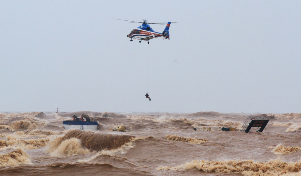 A military helicopter rescues sailors of a submerged ship at Cua Viet Port in Quang Tri province, Vietnam October 11, 2020. u00e2u20acu201d Ho Cau/VNA handout pic via Reuters