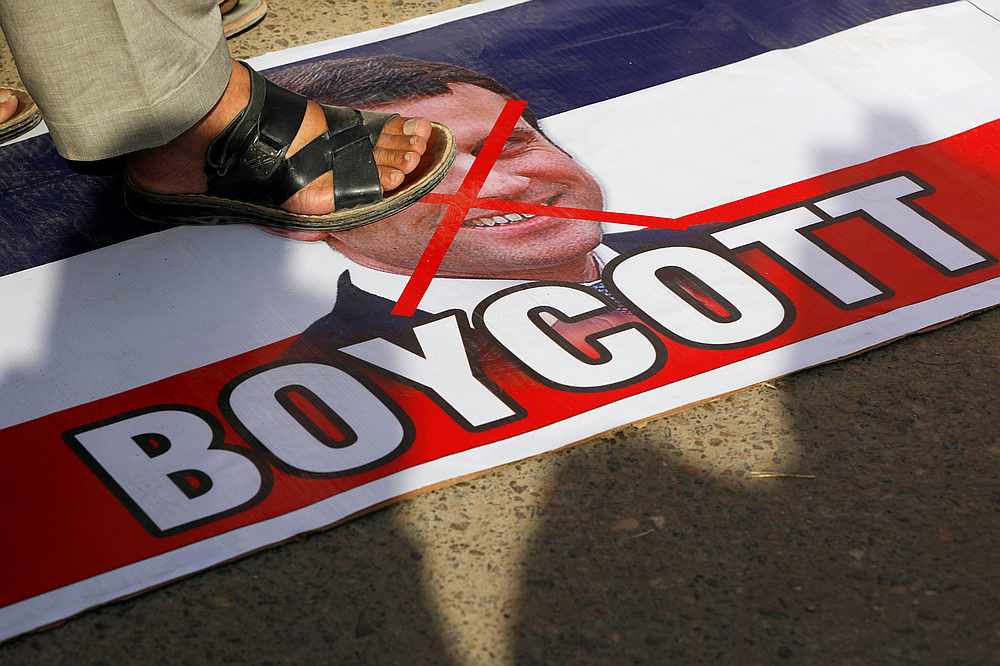 A man steps on a picture of French President Emmanuel Macron during a protest against cartoon publications of Prophet Muhammad in France and Macron's comments, in Karachi, Pakistan October 27, 2020. u00e2u20acu201d Reuters pic