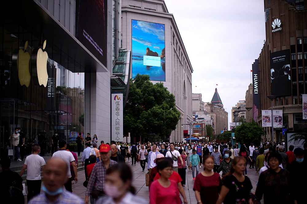 People walk outside an Apple store at a main shopping area following the Covid-19 outbreak in Shanghai, China September 24, 2020. u00e2u20acu201d Reuters pic