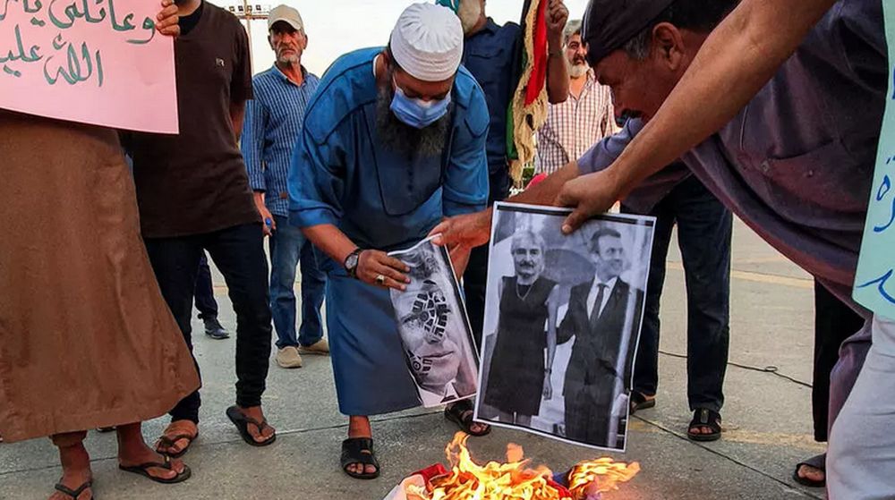 Demonstrators set fire to pictures of French President Emmanuel Macron in Libya. u00e2u20acu201d AFP file pic