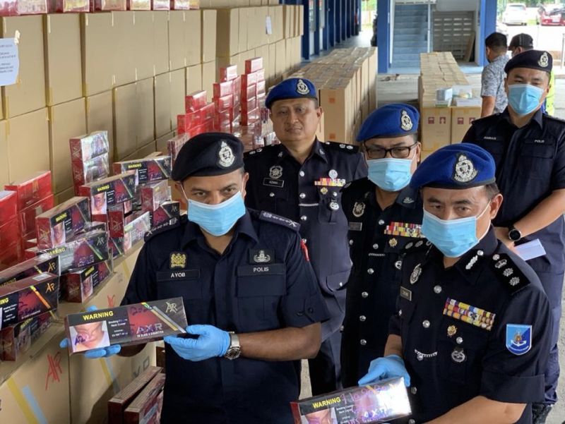Johor police chief Datuk Ayob Khan Mydin Pitchay (left) with the seized contraband cigarettes in Tampoi, Johor Baru October 8, 2020. u00e2u20acu201d Picture by Ben Tan